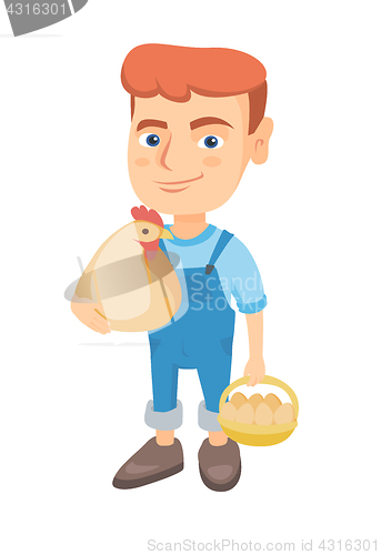 Image of Caucasian boy holding a chicken and hen eggs.