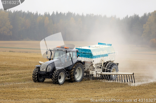 Image of Tractor Spreads Agrilime on Foggy Day 