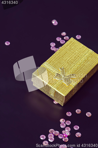 Image of Gold christmas gift box and pink sequins, retro toned