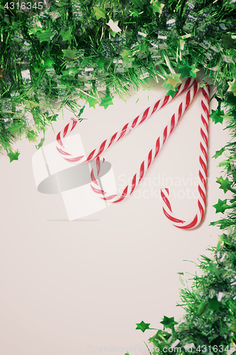 Image of Green tinsel with candy canes decoration, retro toned