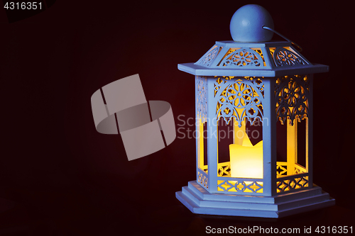 Image of Old lantern on dark background, retro toned