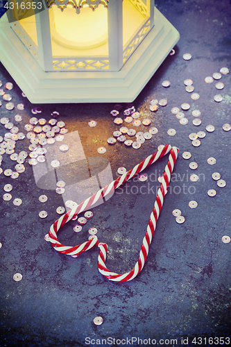 Image of Christmas decorations - lantern and candy canes, retro toned