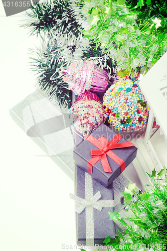 Image of Top view on christmas present boxes and tinsel, retro toned