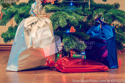 Image of Christmas presents under the tree, retro toned