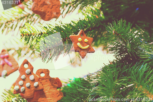 Image of Gingerbread cookies on christmas tree, retro toned