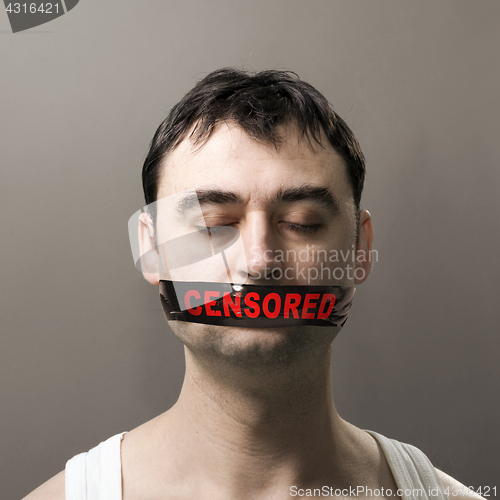 Image of man with censored tape on face