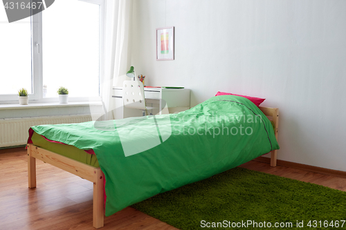 Image of kids room interior with bed, table and accessories