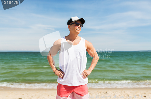 Image of smiling young man on summer beach