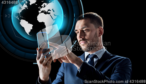 Image of businessman with smartphone and virtual globe