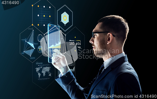 Image of businessman with tablet pc and virtual projections
