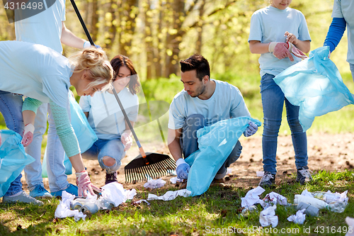 Image of volunteers with garbage bags cleaning park area