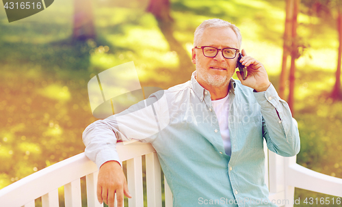 Image of senior man calling on smartphone at summer park