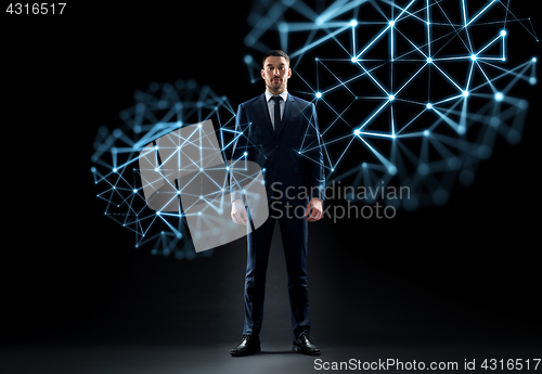 Image of businessman in suit over black