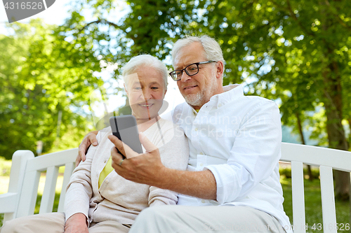 Image of senior couple with smartphone taking selfie 