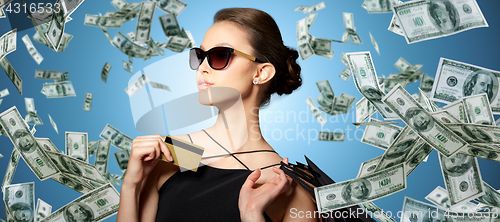 Image of happy woman with credit card and shopping bags