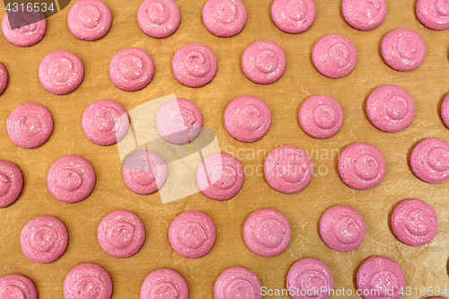 Image of macaron batter or meringue cream on baking paper