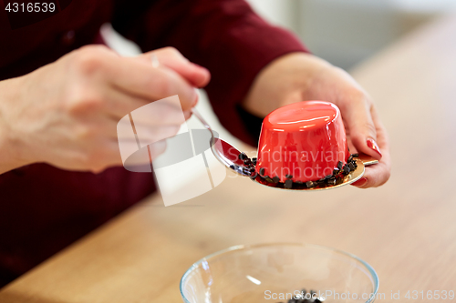 Image of chef decorating mirror glaze cakes at pastry shop