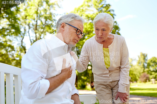 Image of senior man feeling sick at summer park