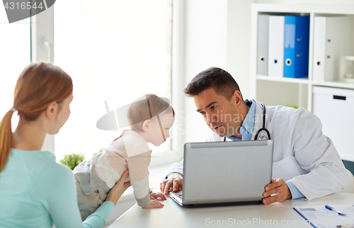 Image of woman with baby and doctor with laptop at clinic