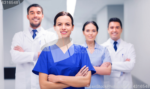 Image of happy group of medics or doctors at hospital