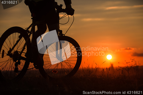 Image of Silhouette of a bike on sky background