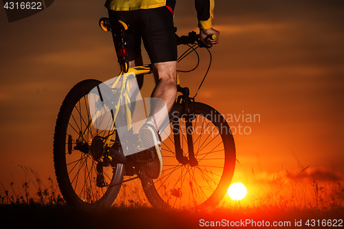 Image of Silhouette of a bike on sky background