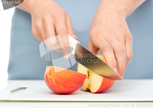 Image of Cook is chopping apple