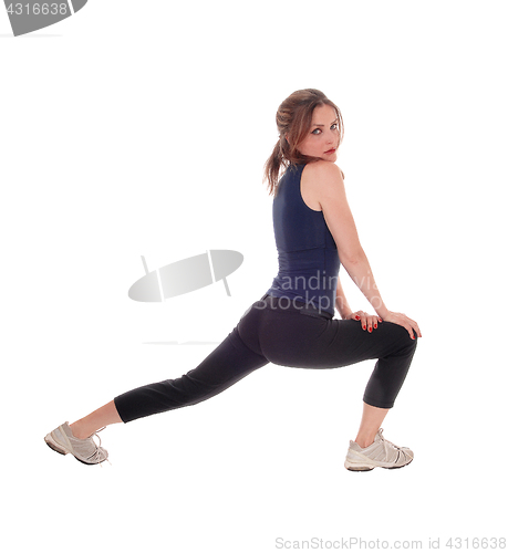 Image of Woman stretch her legs.