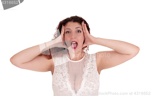 Image of Woman shouting, hands on head.