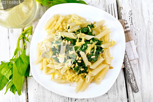 Image of Pasta penne with spinach and nuts on board top