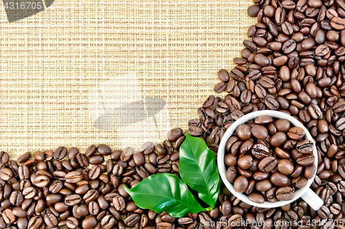Image of Coffee black grains on yellow woven fabric