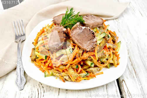 Image of Salad of tongue and carrots on light board