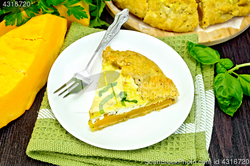 Image of Pie of pumpkin and cheese in plate on napkin