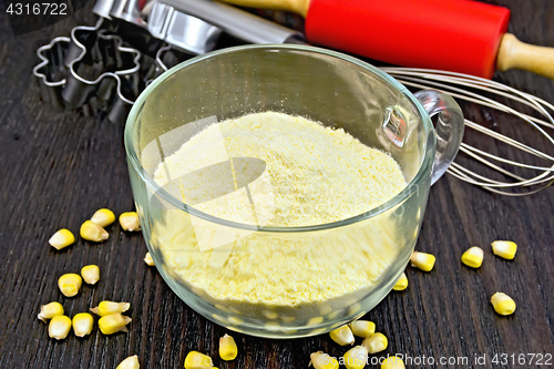 Image of Flour corn in glass cup on dark board