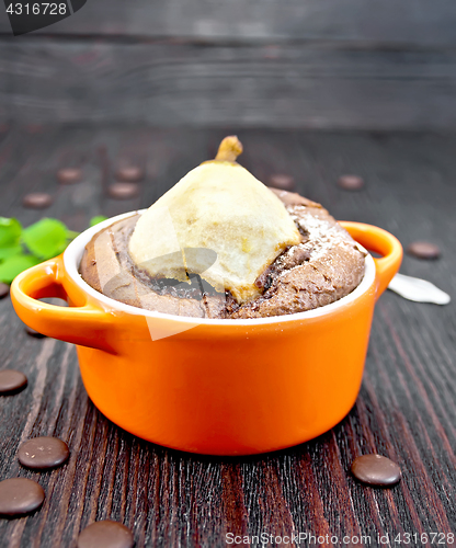 Image of Cake chocolate with pear in red bowl on board