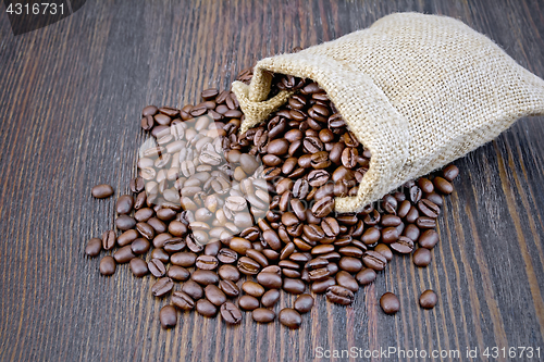 Image of Coffee black grain in bag on dark board