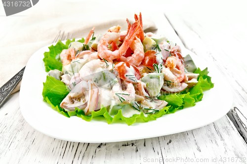 Image of Salad with shrimp and avocado in plate on light board