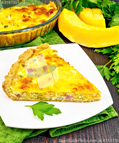 Image of Quiche with pumpkin and bacon in plate on board