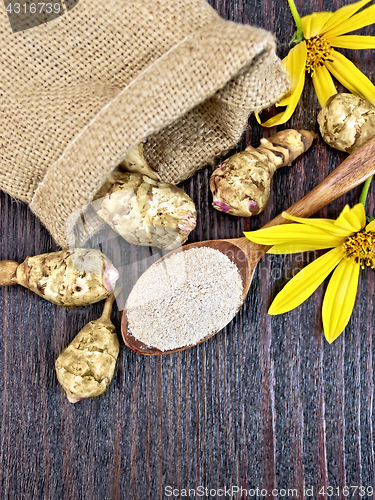 Image of Flour of Jerusalem artichoke in spoon with vegetable on board to