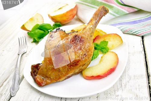 Image of Duck leg with apple on board