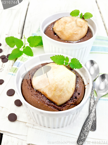 Image of Cake chocolate with pear and mint in white bowl on board