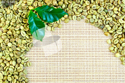 Image of Coffee green grains on yellow woven fabric