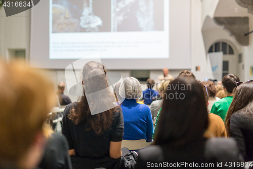 Image of Man giving presentation in lecture hall at university.