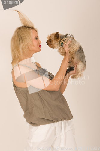 Image of Fashionable woman with dog