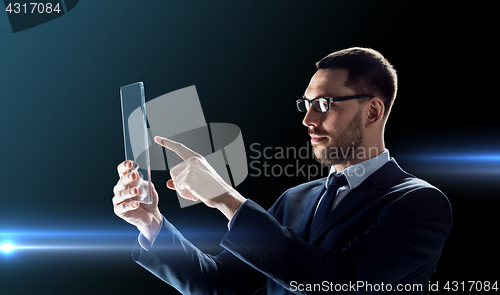 Image of businessman working with transparent tablet pc