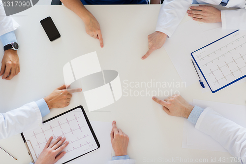 Image of group of doctors with cardiograms working at table