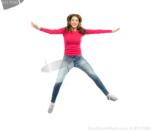 Image of smiling young woman jumping in air