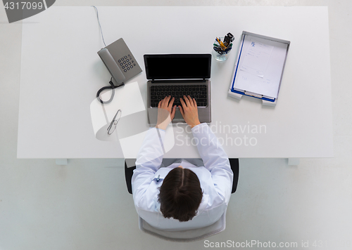 Image of doctor typing on laptop at clinic