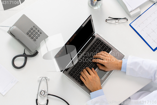 Image of doctor hands typing on laptop at clinic