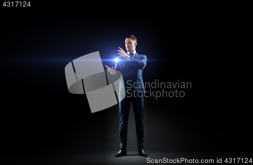 Image of businessman with laser light over black